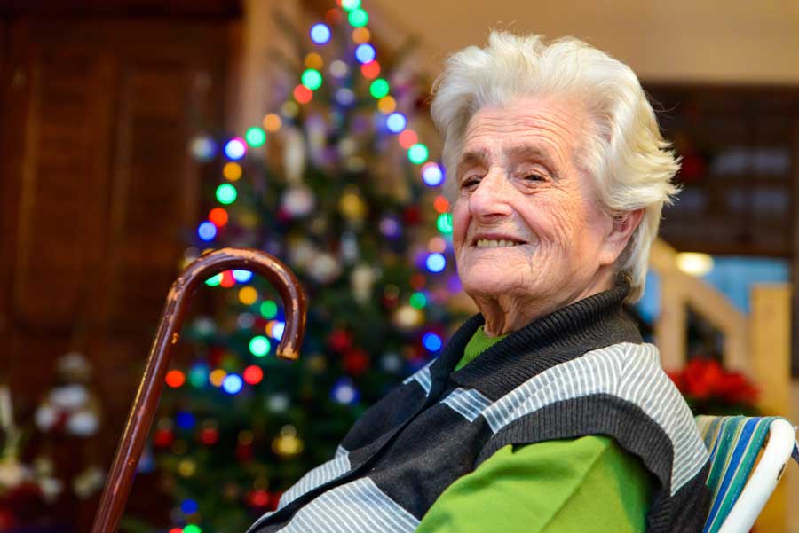 Senior woman with Christmas tree