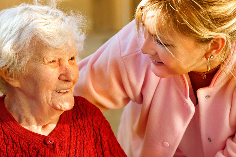 Young woman speaking to senior relative